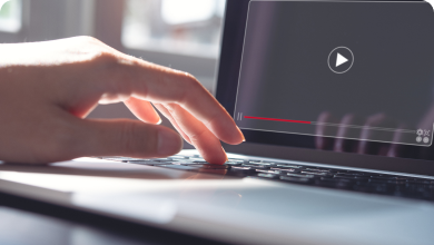 Hands typing on a laptop